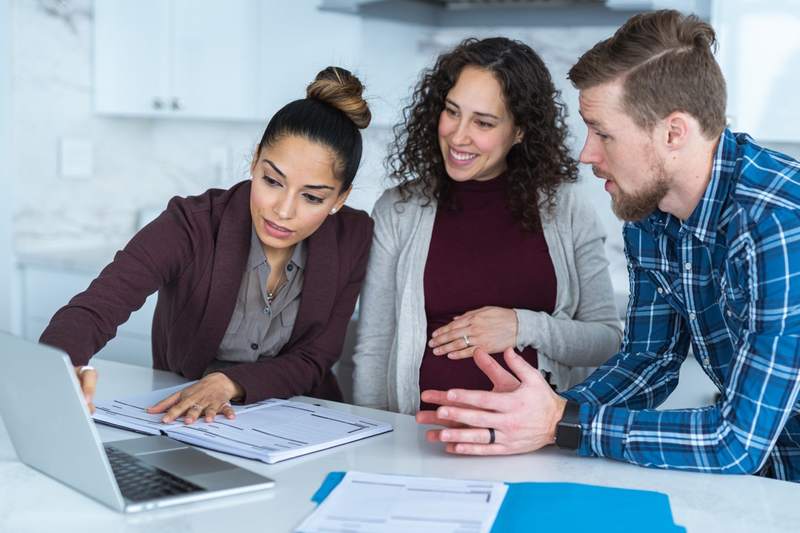 A couple and Realtor calculate their loan-to-value ratio.