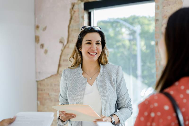 An agent meets with a client in a home under construction.