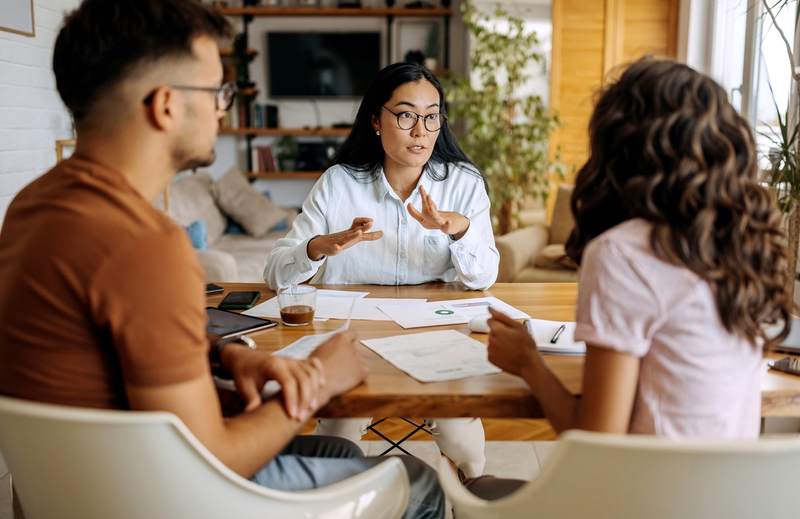 A couple meets with a financial advisor to discuss their home loan options and private mortgage insurance.