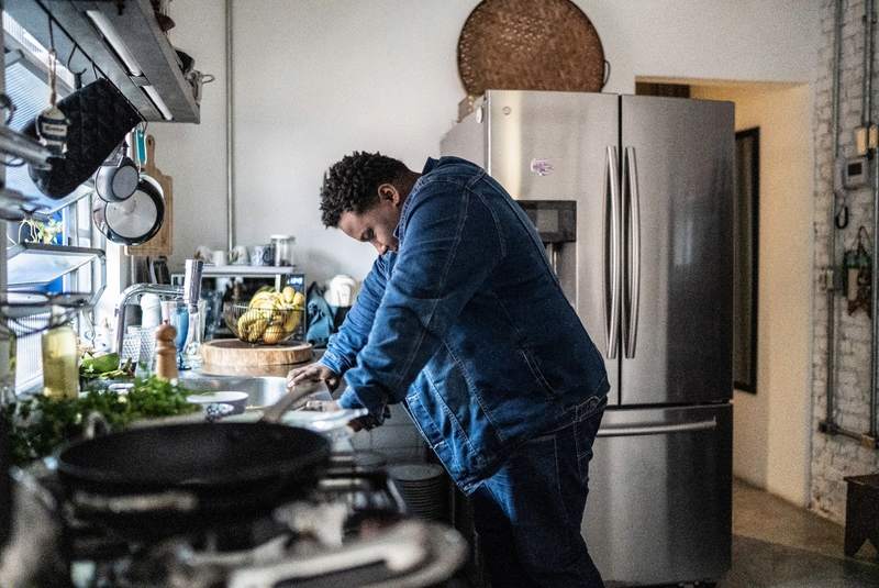 Man experiences homebuyer's remorse in a kitchen.