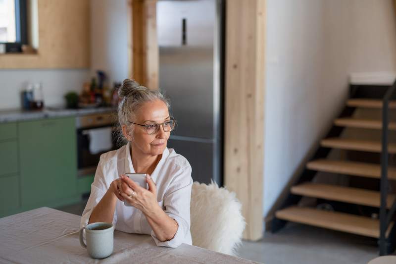 Mother sits at the kitchen table in her new home.