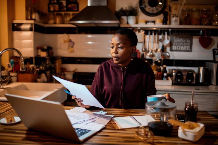 Woman looking over her finances and saving for a down payment.